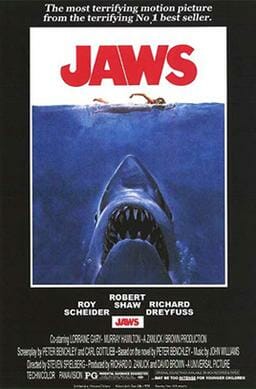 Movie poster shows a woman in the ocean swimming to the right. Below her is a large shark, and only its head and open mouth with teeth can be seen. Within the image is the film's title and above it in a surrounding black background is the phrase "The most terrifying motion picture from the terrifying No. 1 best seller." The bottom of the image details the starring actors and lists credits and the MPAA rating.